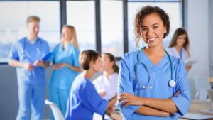 A nurse & her colleague healthcare professionals wearing healthcare uniforms also known as medical scrubs
