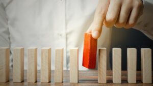 A man picking a red wooden block showcasing employee's unplanned absence management system