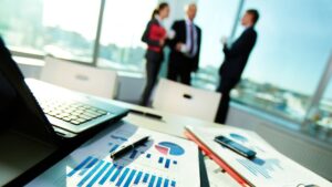 Three employees discussing PPC marketing strategy