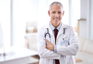 Portrait of a mature medical doctor smiling with folded arms