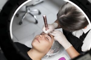 young woman going through microblading treatment
