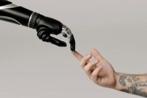 A human hand touches a robot hand