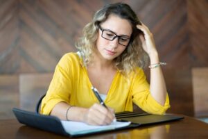 serious female entrepreneur writing ideas startup project