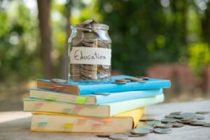 putting money coins saving in glass bottle for concept investmen
